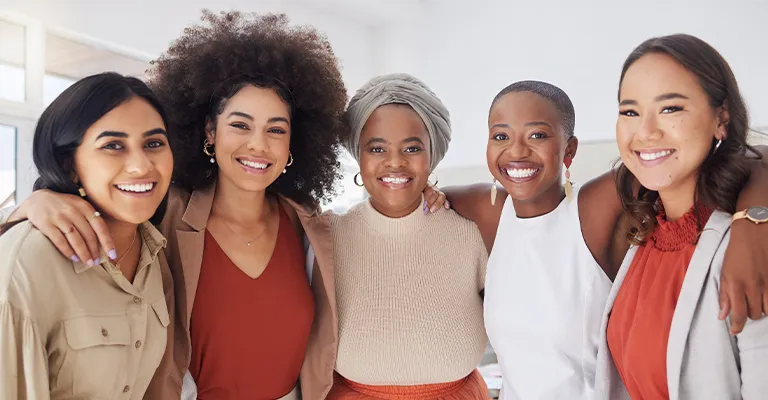 A group of migrant women smiling