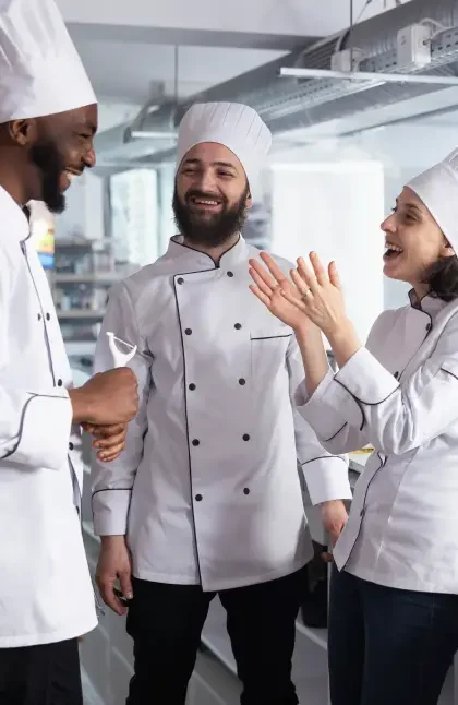 3 chefs talking in the kitchen
